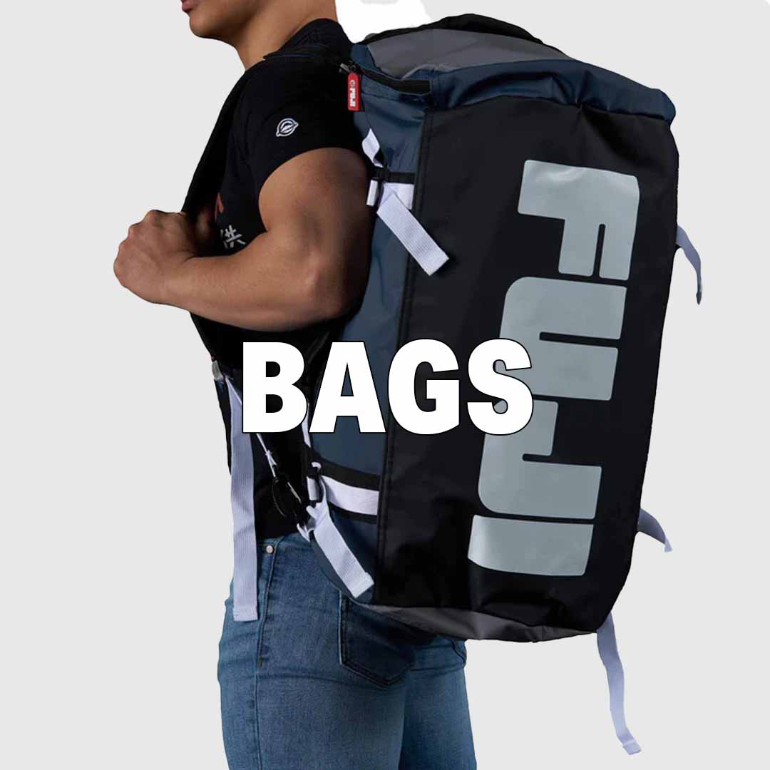 A person wearing a black and gray FUJI sports duffle bag on their back, with the word BAGS in bold white letters over the image. The background is light gray.