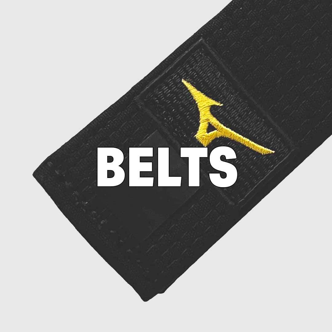 Close-up of a black martial arts belt with a yellow logo, featuring the word BELTS in bold white letters across the center.