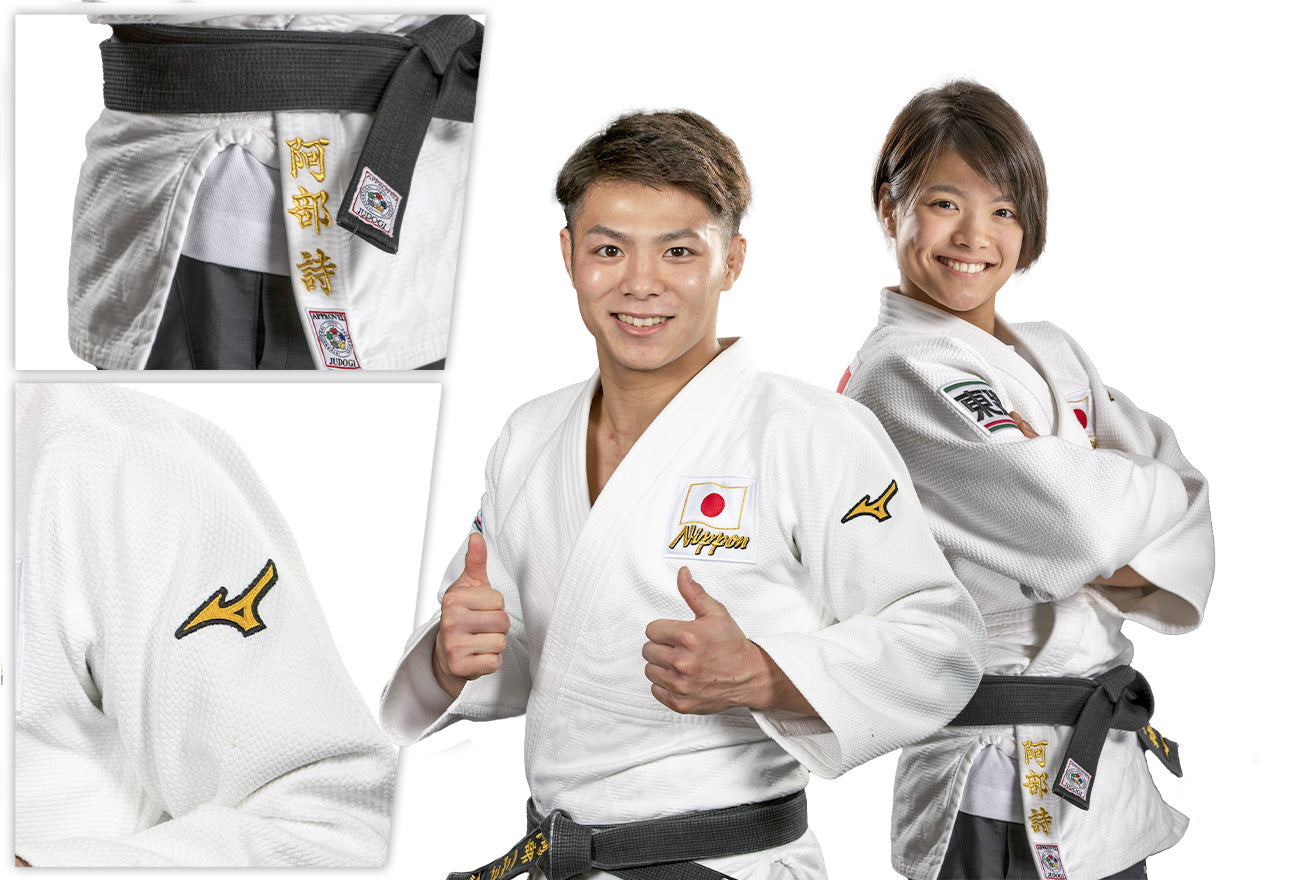 Two judo athletes in white uniforms and black belts pose confidently; the man gives a thumbs-up and the woman stands with arms crossed. Insets show uniform details, including embroidered patches and logos.