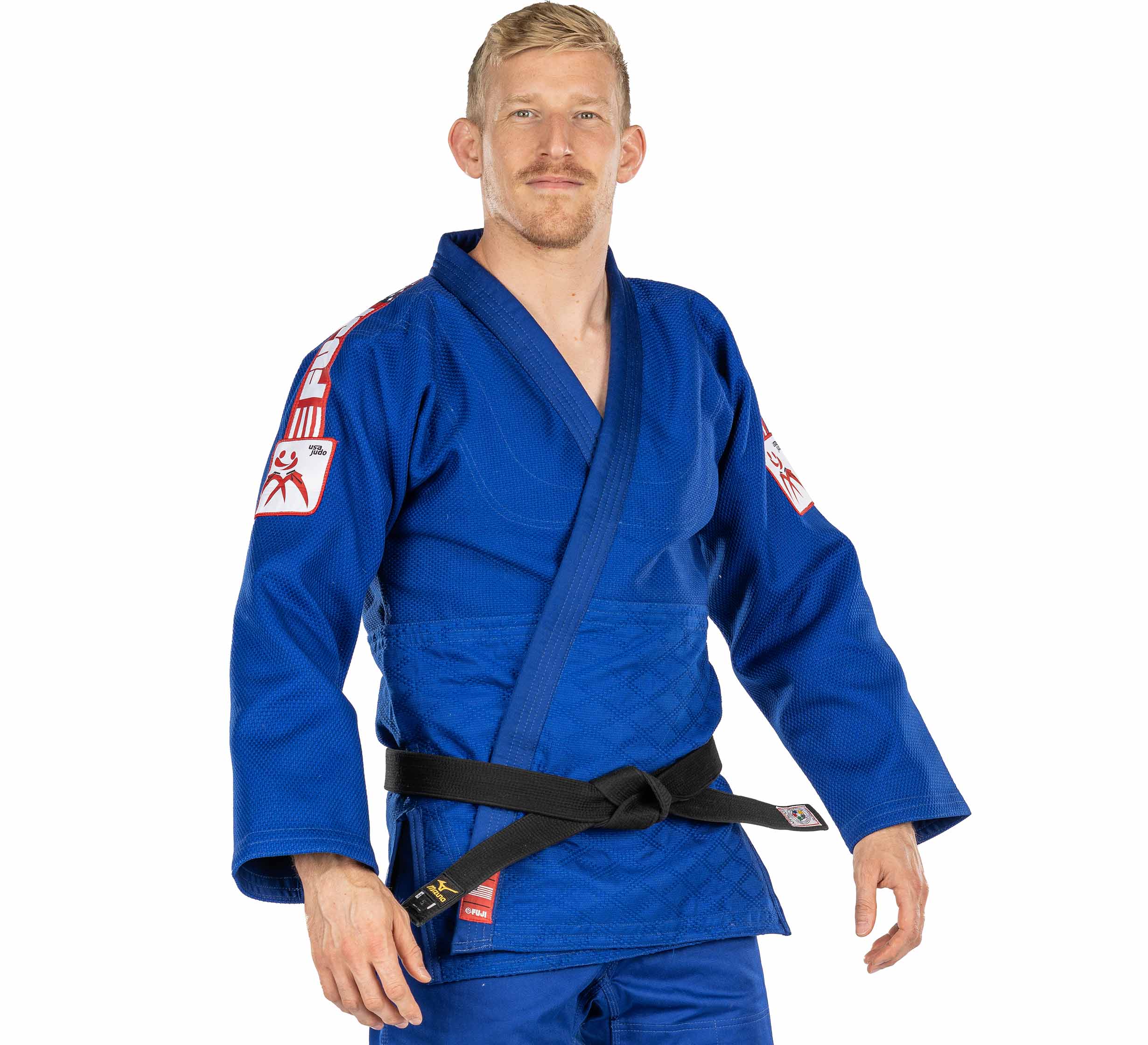 A man with short blond hair and a mustache wears the USA Judo Double Weave Gi 2.0 Blue with red and white patches and a black belt, standing facing forward with a neutral expression.